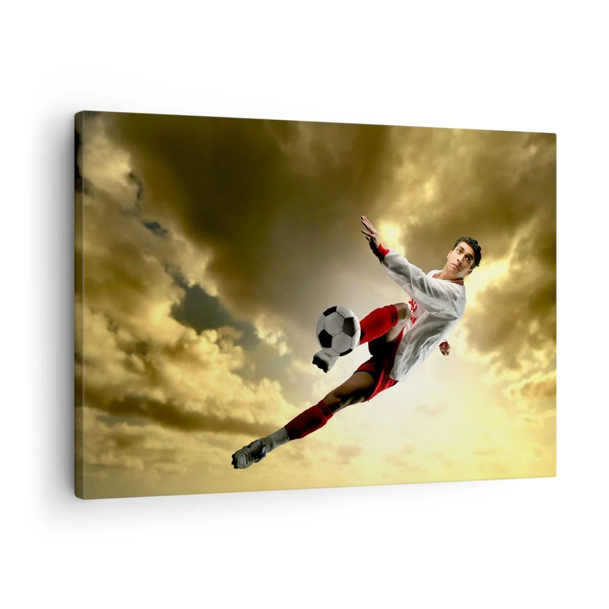 Schilderen op canvas - Een voetballer in een dynamische sprong die de bal tegen de lucht schiet - 70x50cm - Voetbal hemel - Moderne wanddecoratie voor woonkamer en slaapkamer ARTTOR
