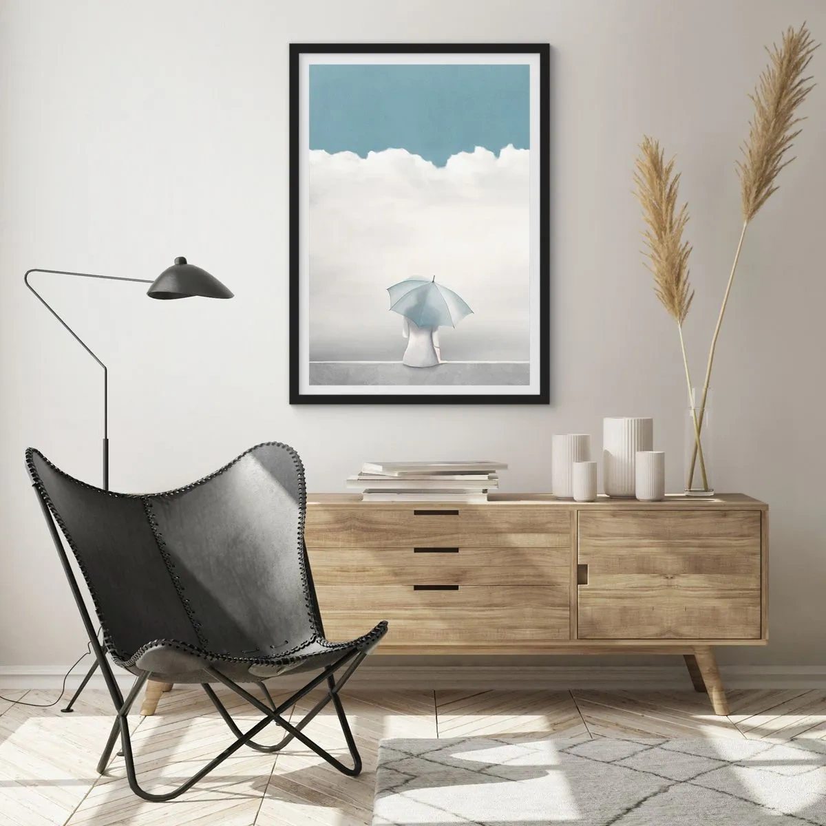 Poster in een zwarte lijst - Een figuur met een paraplu zittend op een richel tussen de wolken - 50x70cm - Op de rand van realiteit en dromen - Moderne wanddecoratie voor woonkamer en slaapkamer ARTTOR