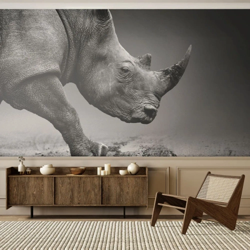 Fotobehang Premium Sand - Onstuitbare kracht - Neushoorn, Dieren, Afrika - 100x70 cm
