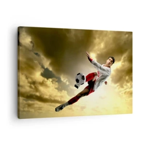 Schilderen op canvas - Een voetballer in een dynamische sprong die de bal tegen de lucht schiet - 70x50cm - Voetbal hemel - Moderne wanddecoratie voor woonkamer en slaapkamer ARTTOR