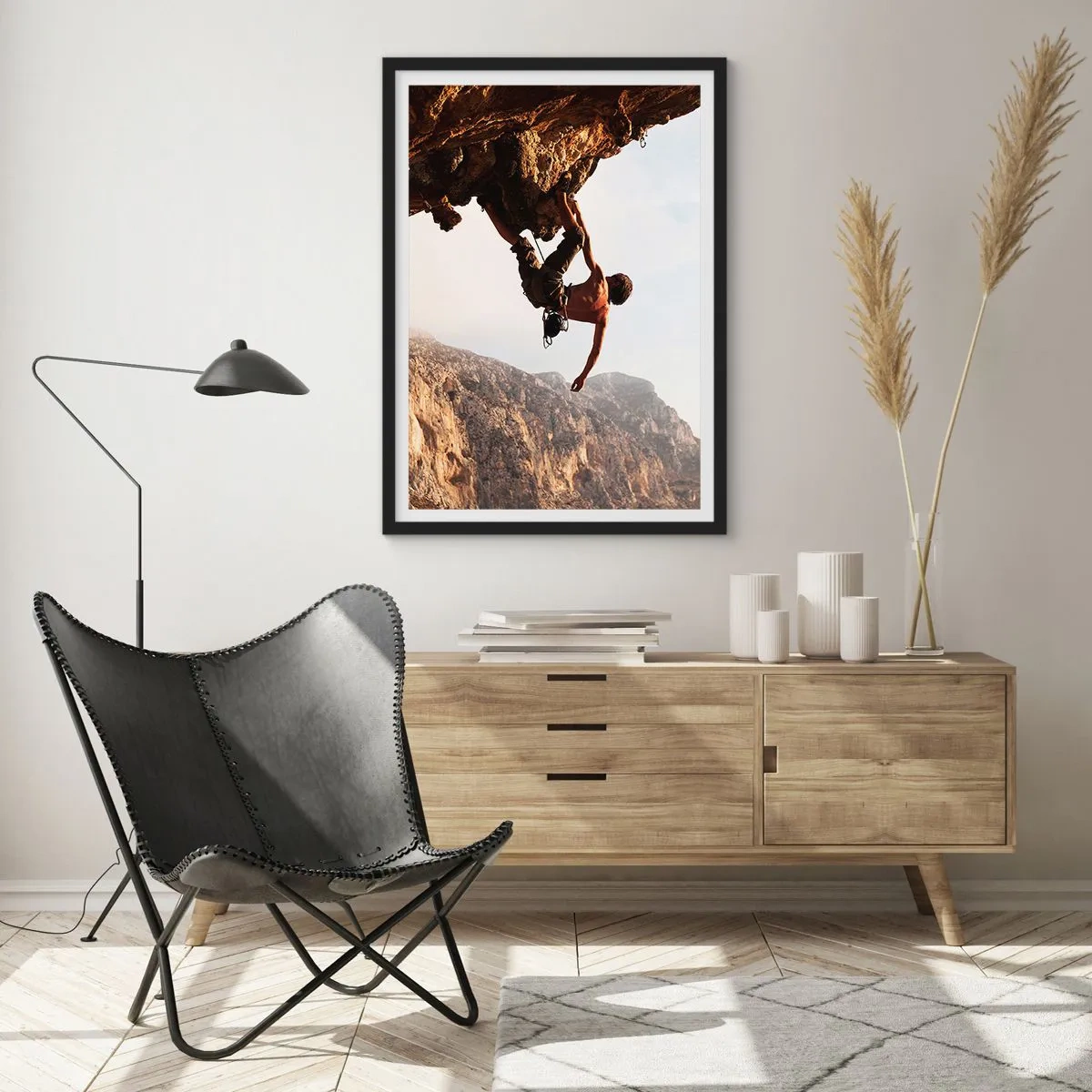 Poster in een zwarte lijst - De wereld gekrompen in een hand op een rotsblok  - 70x100 cm